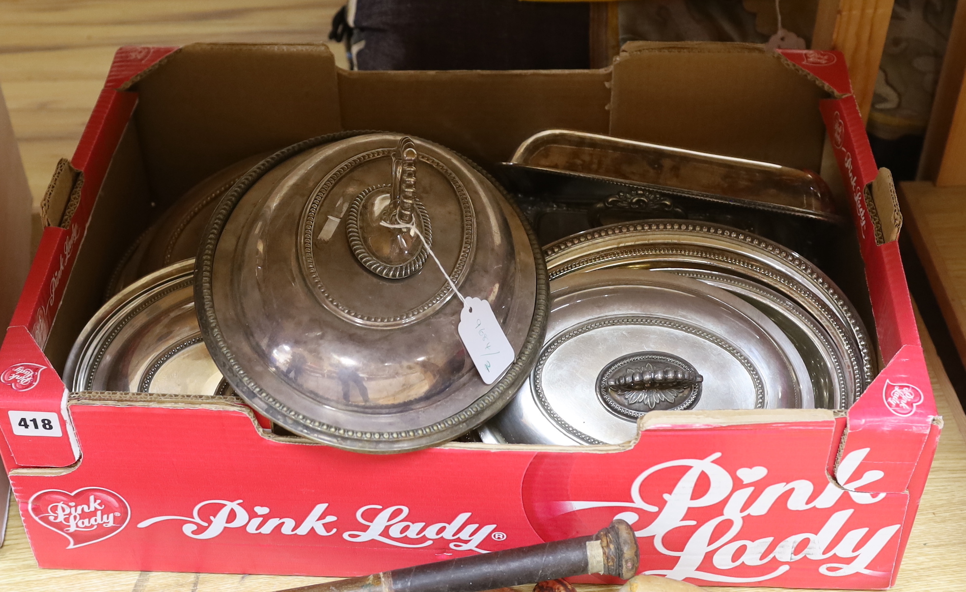 A collection of silver plated entree dishes and covers